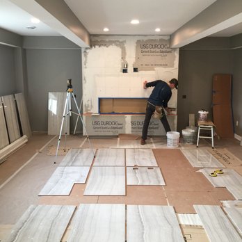 Circa Tile And Stone - Large porcelain tile fireplace installation underway - Tiling Near Me Circa Tile And Stone - Large porcelain tile fireplace installation underway - Tiling Near Me