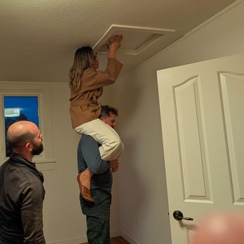 Sarah Ridge - District Homes - Sarah gets on her husband's shoulders to check out the attic during a walkthrough  Hands-on! - Real Estate Agents Near Me - Berkeley, California
