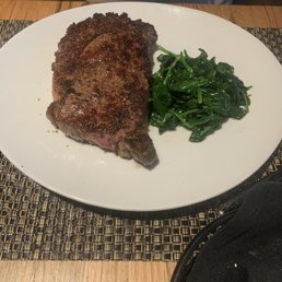 Delmonico steak and fresh sautéed spinach