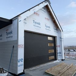 Evolve Garage Doors - #1 - 14' X 8' Raynor Black Modern Flush Garage Door Installed on a new Twin home in Ranchester Wy