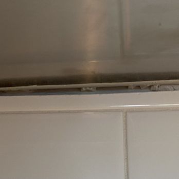 Ashton Woods - Vent meets backsplash grout falling out - Real Estate Services Near Me