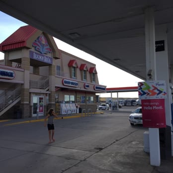 Town Pump Food Store - a woman standing in front of a gas station - Convenience Stores Near Me - Shelby, Montana Town Pump Food Store - a woman standing in front of a gas station - Convenience Stores Near Me - Shelby, Montana