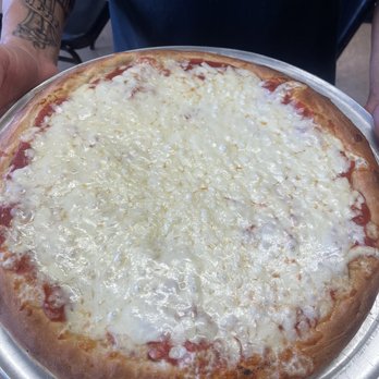 Anthony's Pizza & Pasta - a man holding a pizza - Pizza Near Me - West Islip, New York