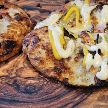 Bobby's Hot And Cheesy - The Cuban and Aloha Pizzas on a beautiful woodgrain plate. - Pizza Near Me - Roanoke, Virginia Bobby's Hot And Cheesy - The Cuban and Aloha Pizzas on a beautiful woodgrain plate. - Pizza Near Me - Roanoke, Virginia