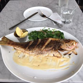 Mignonette - Whole Fish of the Day: Yellowtail Fish & Chardonnay Sauce with Sautéed Watercress - New American Near Me - Miami, Florida Mignonette - Whole Fish of the Day: Yellowtail Fish & Chardonnay Sauce with Sautéed Watercress - New American Near Me - Miami, Florida