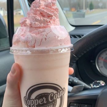 Copper Coins Coffee - a hand holding a cup of ice cream - Coffee & Tea Near Me - Buckley, Washington