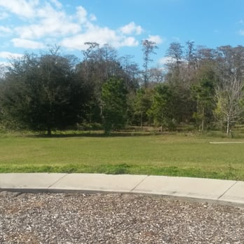 Airport Lakes Park - Walking trail behind the trees, and open grassy areas for playing and relaxing - Parks Near Me - Orlando, Florida Airport Lakes Park - Walking trail behind the trees, and open grassy areas for playing and relaxing - Parks Near Me - Orlando, Florida