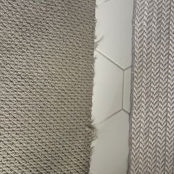 Carpetland - Frayed at seams with hard surfaces.