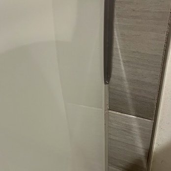 Man and a Van Handyman - Benjamin used the wrong caulk color (darker shade) and didn't fully remove the old caulk. Therefore, the remaining work is patchy and ugly. - Handyman Near Me