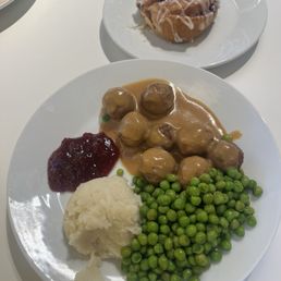 Plant-based meatballs plate and cinnamon roll Plant-based meatballs plate and cinnamon roll