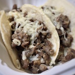 two tacos in a styrofoam container two tacos in a styrofoam container