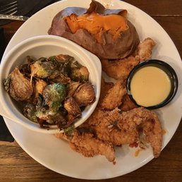Hand-Breaded Chicken Tenders, Sweet Potato, and Crispy Brussels Sprouts. House made Honey mustard for dipping.
