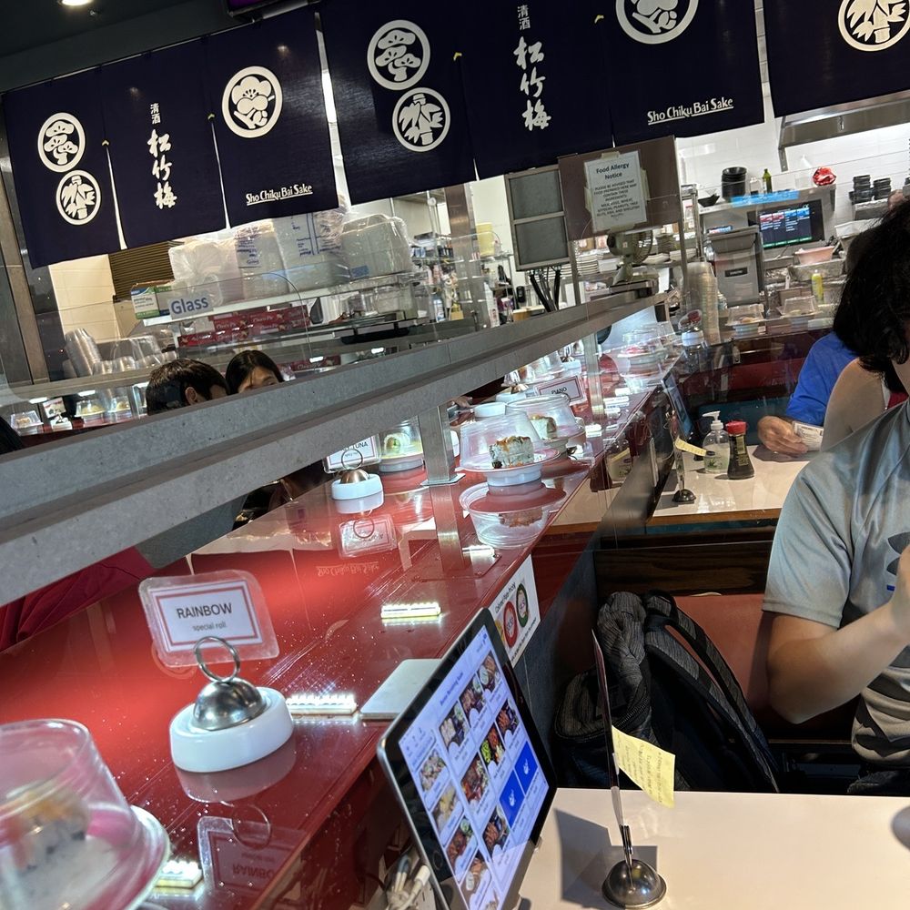 Bento Revolving Sushi - a man sitting at a table - Sushi Bars Near Me - Fair Oaks, California