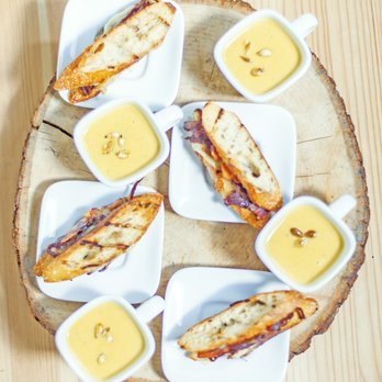 Farmer and the Fig - Gruyere, Apples  and Caramelized Onion Grilled Cheese on a Sliced Sourdough Baguette with Bacon. Served with Cream of Butternut Squash. - Caterers Near Me