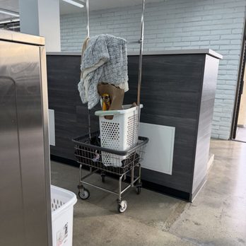 Top Spin Laundry - Cart being held onto by a baskets and clothes hanging at the top - Laundromat Near Me - San Fernando Valley, California Top Spin Laundry - Cart being held onto by a baskets and clothes hanging at the top - Laundromat Near Me - San Fernando Valley, California