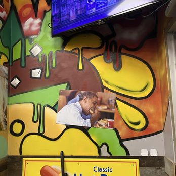 Devil Dawgs-Gold Coast - Wall decor with an image of President Barack Obama eating. - Hot Dogs Near Me - Chicago, Illinois Devil Dawgs-Gold Coast - Wall decor with an image of President Barack Obama eating. - Hot Dogs Near Me - Chicago, Illinois
