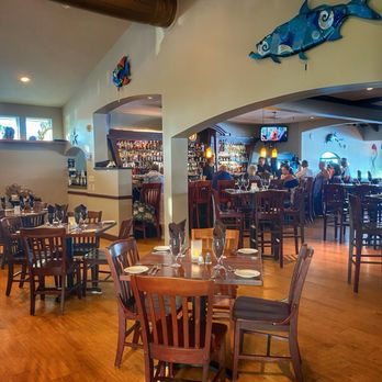 Salt Rock Grill - Dining area with view of the bar - New American Near Me - Indian Shores, Florida Salt Rock Grill - Dining area with view of the bar - New American Near Me - Indian Shores, Florida