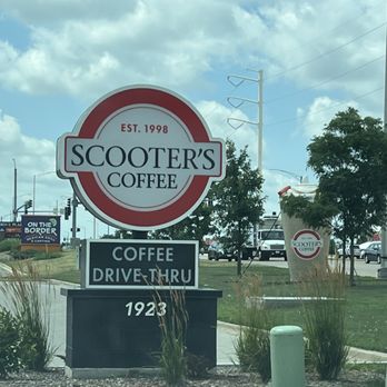 Scooter's Coffee - Scooter's - A sign for Scooter's Coffee, established in 1998, advertises coffee and drive-thru service, with a large coffee cup graphic in the background. - Coffee & Tea Near Me - Naperville, Illinois