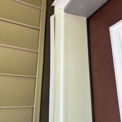 Bedrock Homes - Door install is not complete. Material hanging loose