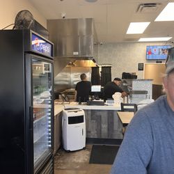 La Toxica Taco Shop - The cook in the background/soda fridge to the left.