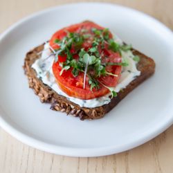 Starter Bakery - Heirloom tomato and herby goat cheese on spelt rye toast! It's topped with greens, a dash of sea salt and is now available.
