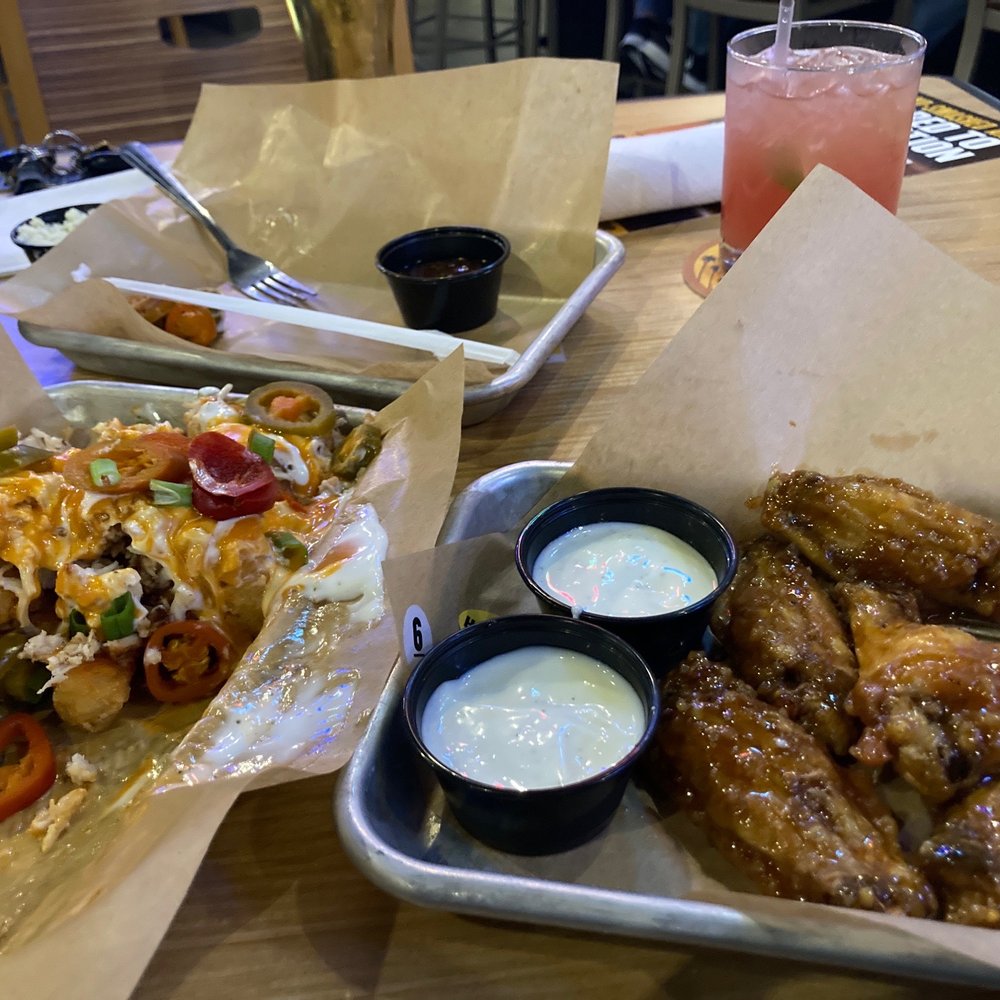 a tray of chicken wings and a salad a tray of chicken wings and a salad