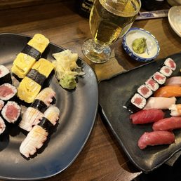 Tuna roll, tamago nigiri, octopus nigiri, and sushi dinner on the right with fresh wasabi Tuna roll, tamago nigiri, octopus nigiri, and sushi dinner on the right with fresh wasabi