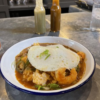 Rising Son - Wild GA Shrimp and Grits Wild GA Shrimp and Grits... accompanied by the red and green house made hot sauces - Southern Near Me - Avondale Estates, Georgia Rising Son - Wild GA Shrimp and Grits Wild GA Shrimp and Grits... accompanied by the red and green house made hot sauces - Southern Near Me - Avondale Estates, Georgia