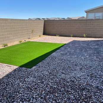 Domestic Landscape - Backyard - turf and plants around wall - Tree Services Near Me