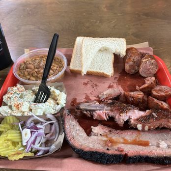 Terry Black's Barbecue - Brisket,jalapeno sausage and a rib.Along with beans,potato salad a couple slices of bread and pickles and onions. - Barbeque Near Me - Fort Worth, Texas Terry Black's Barbecue - Brisket,jalapeno sausage and a rib.Along with beans,potato salad a couple slices of bread and pickles and onions. - Barbeque Near Me - Fort Worth, Texas