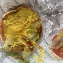 Enough mustard to drown. A baby squirt of ketchup on one end. No onions. Small slushie and burnt corn dog.