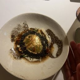 Poached (barely) egg with gold leaf.