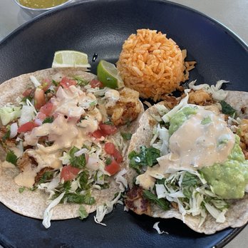 Caliente Mexican Grill - Shrimp taco on wheat tortilla on the left, lobster taco on wheat tortilla on the right, side of rice, green salsa - Mexican Near Me - Scottsdale, Arizona Caliente Mexican Grill - Shrimp taco on wheat tortilla on the left, lobster taco on wheat tortilla on the right, side of rice, green salsa - Mexican Near Me - Scottsdale, Arizona
