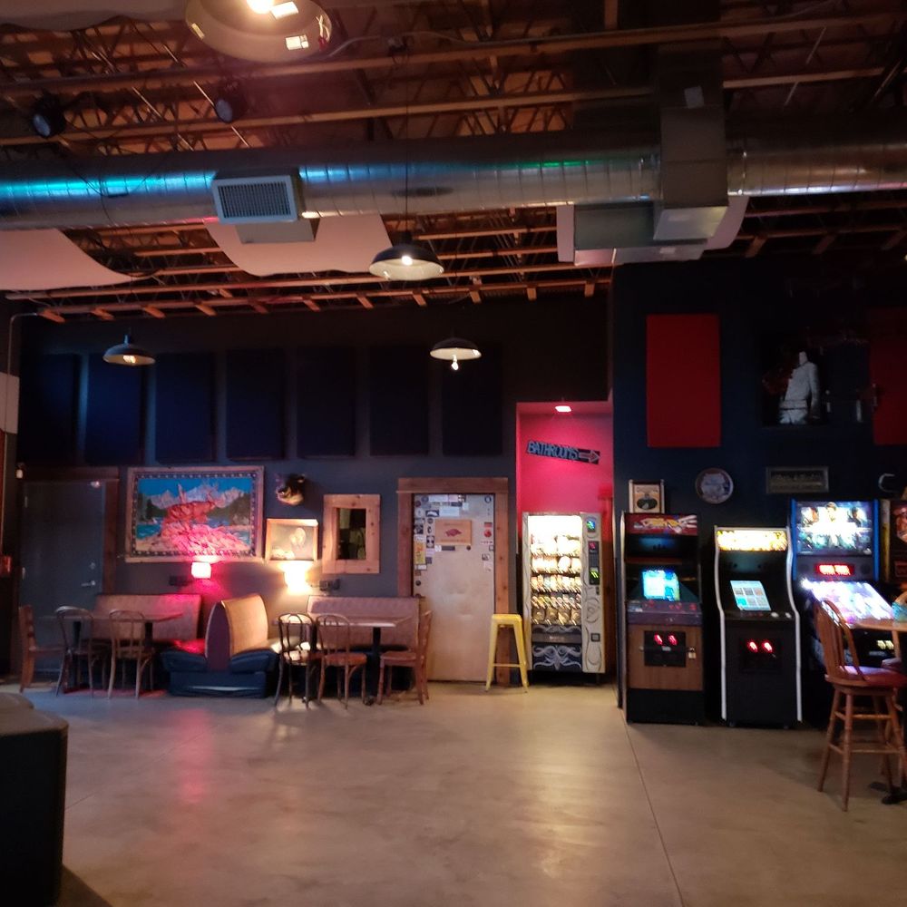 large room with arcade machines large room with arcade machines