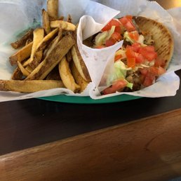 Greek chicken on a pita with fries Greek chicken on a pita with fries