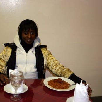 Drelyse African Restaurant - girls sits with food at Drelyse - African Near Me - Columbus, Ohio