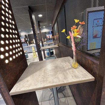 McDonald's - a table with a vase of flowers on it - Fast Food Near Me - Elkview, West Virginia