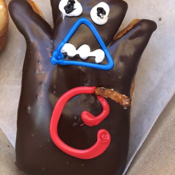 Voodoo Doughnut - Voodoo doll donut! Raised yeast doughnut filled with raspberry jelly topped with chocolate frosting and a pretzel stake. - Bakeries Near Me - Orlando, Florida Voodoo Doughnut - Voodoo doll donut! Raised yeast doughnut filled with raspberry jelly topped with chocolate frosting and a pretzel stake. - Bakeries Near Me - Orlando, Florida