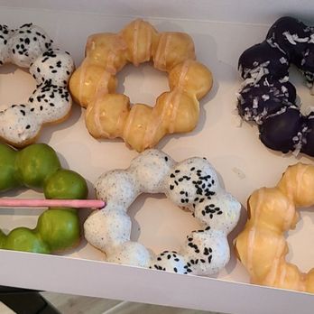 Cha Papi - Mochi donuts - is top left to right: black sesame, passion fruit, ube coconut, and the bottle left is machi. - Donuts Near Me - West Hartford, Connecticut Cha Papi - Mochi donuts - is top left to right: black sesame, passion fruit, ube coconut, and the bottle left is machi. - Donuts Near Me - West Hartford, Connecticut
