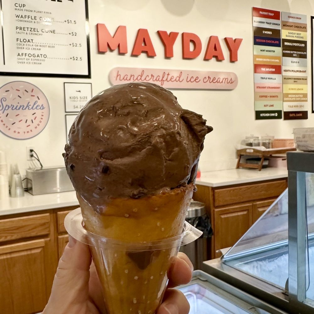 Mayday Ice Cream - a hand holding an ice cream cone - Ice Cream & Frozen Yogurt Near Me - St. Augustine, Florida Mayday Ice Cream - a hand holding an ice cream cone - Ice Cream & Frozen Yogurt Near Me - St. Augustine, Florida
