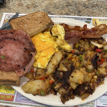 The Cracked Egg Cafe - Breakfast Binge; bacon, pork ring, ham, Sausage Link, home fries, eggs with cheese and toast. - Breakfast & Brunch Near Me - Galloway, New Jersey
