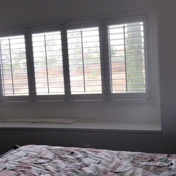 Sav On Blinds - White shutters in master bedroom - Shades & Blinds Near Me
