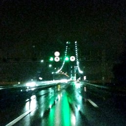 Ponte 25 de Abril Bridge entering Lisbon, Portugal on a cold, rainy night Ponte 25 de Abril Bridge entering Lisbon, Portugal on a cold, rainy night