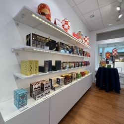 ROYCE' Chocolate - One side of the store, descriptions listed next to each offering.