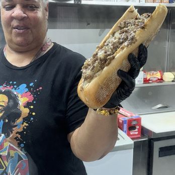 Philly Jawnz - Chef Natalie holding a steak with fried onions and cooper sharp cheese - Food Trucks Near Me - Los Angeles, California Philly Jawnz - Chef Natalie holding a steak with fried onions and cooper sharp cheese - Food Trucks Near Me - Los Angeles, California