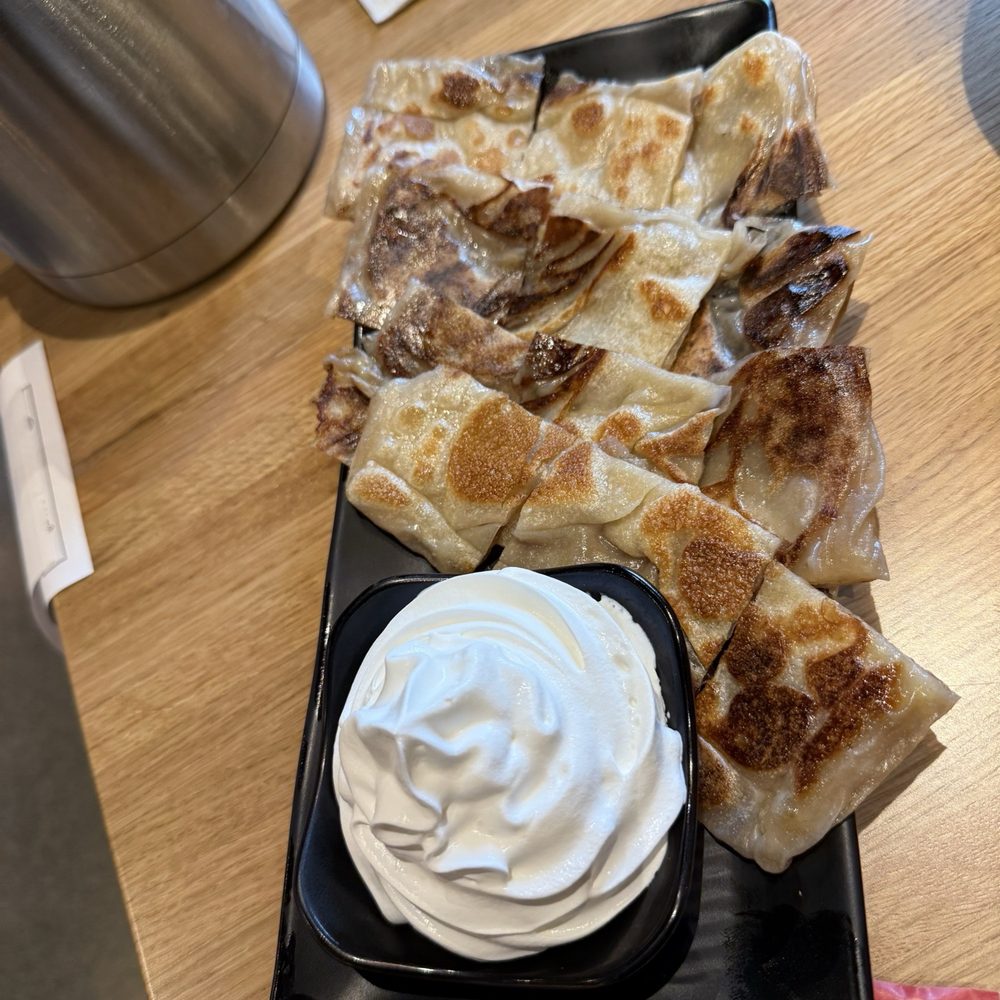 Banana naan bread with side of whip cream for dipping Banana naan bread with side of whip cream for dipping