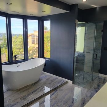 Rew Construction - a bathtub in a bathroom with a view - Painters Near Me Rew Construction - a bathtub in a bathroom with a view - Painters Near Me