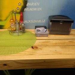 JahNyas Caribbean Cuisine - Scotch bonnet sauce and dominoes available on the benches