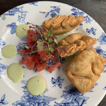 FINKA Table & Tap - Mini Empanadas of the Day vaca frita so good had a mix of flavors with a side of their cilantro sauce. - Asian Fusion Near Me - Miami, Florida FINKA Table & Tap - Mini Empanadas of the Day vaca frita so good had a mix of flavors with a side of their cilantro sauce. - Asian Fusion Near Me - Miami, Florida