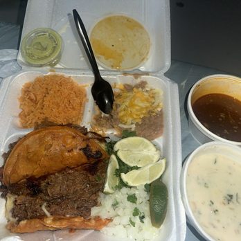 Nueva Era Taqueria - 1. 2 Quesabirria Tacos rice and beans, white queso dip, and green sauce - Mexican Near Me - Decatur, Texas